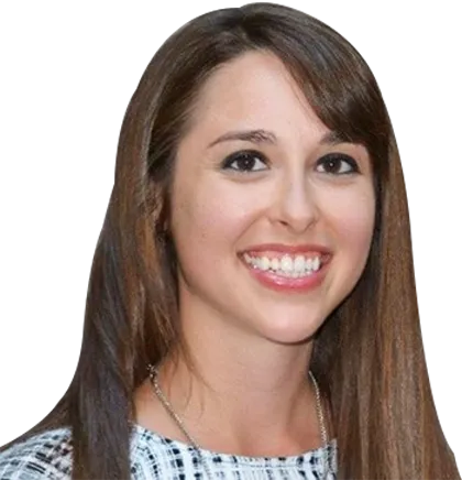 A woman with long straight brown hair wearing a black and white checkered top smiles at the camera against a plain background, looking ready to explore Rosemont Distillery Tours.